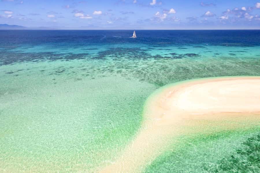 From Port Douglas: Outer Reef Cruise by Luxury Catamaran - Sailing from Port Douglas beneath the Daintree Mountains